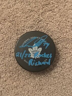 Toronto Maple Leafs Autographed Austin MatthewHockey Puck in Black with Blue Ink